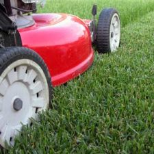 A picture of a lawn mower mowing grass